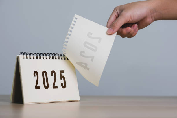 A person's hand is pulling a calendar from 2024 to 2025. 2025 Happy New year background. Setup objective target business cost and budget planning of new year concept.