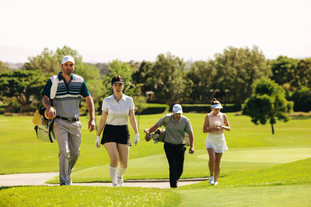 istock Group of golfers with golf bags walking on a golf course during a match 2172329186