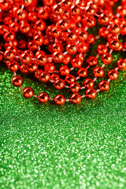 istock Red Sparkling Beads on Green Glitter Background, Christmas and New Year Decorations, Copy Space 2172329709