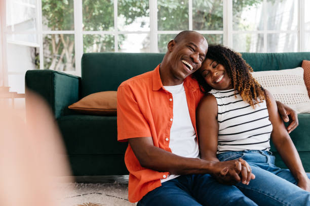 istock Couple laughing together at home 2172332626