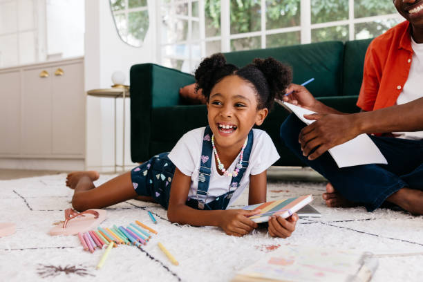 istock Young daughter enjoying a creative drawing session with father at home 2172332823