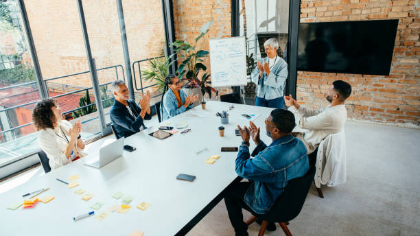 istock Diverse team giving applause during a project presentation in a sleek, stylish conference room 2172333330