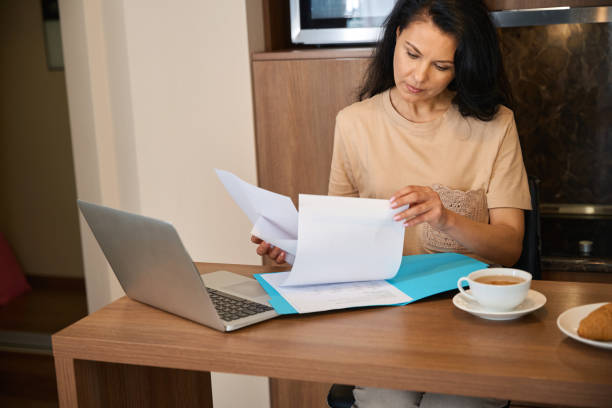 istock Female works with documents over breakfast in her room 2172334202