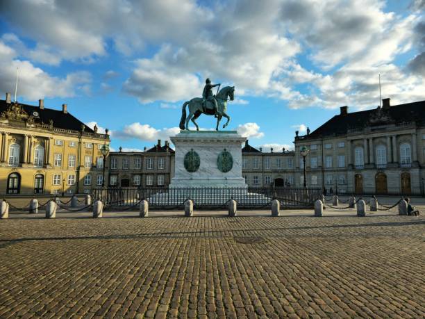 Amalienborg Slotsplads Copenhagen with the sourrounding official residence for the Danish royal family . Captured at sunset during summer season.