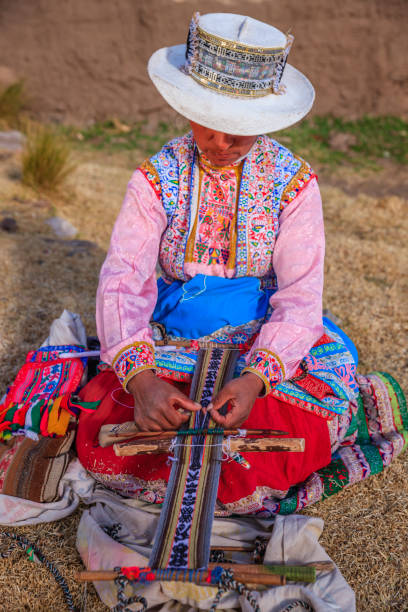 istock Peruvian woman weaving near Colca Canyon, Peru 2172335677