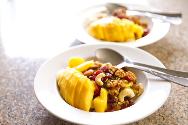 Rice flour or khao Mao mixed with corn and ripe mango in a white plate, food background