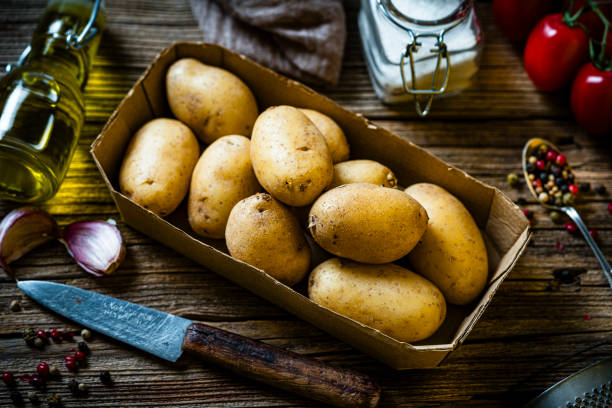 istock Fresh organic raw fingerling potatoes shot from above on rustic table. 2172345041