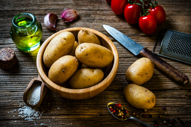 istock Fingerling potatoes in a small wooden bowl on rustic table. 2172345043