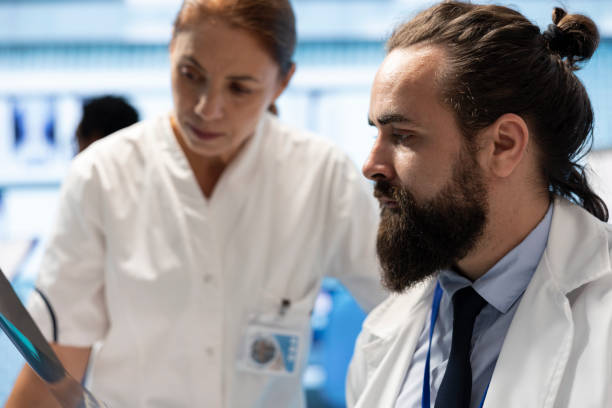 istock Medical experts analyzing x ray results and discuss treatment options 2172346043