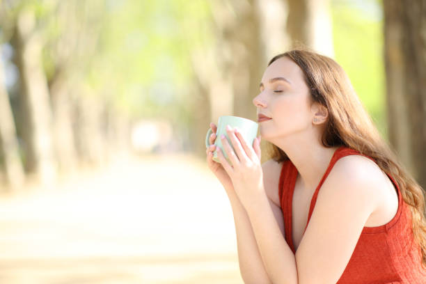 istock Woman smelling coffee in a park 2172350710