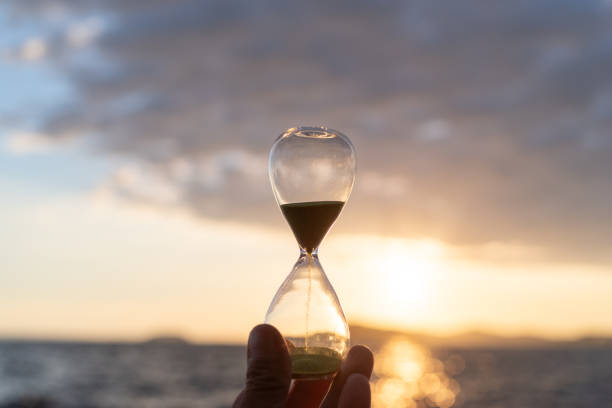 istock Sunset sea and hourglass 2172351426