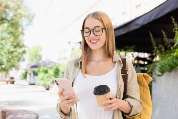 istock Happy woman using smart phone in a city 2172355004