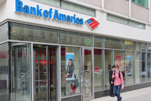 Bank of America branch Person walks by Bank of America branch in Philadelphia. Bank of America is the 2nd largest bank holding in the USA with assets of 2.1 trillion USD (2013). bank-of-america stock pictures, royalty-free photos & images