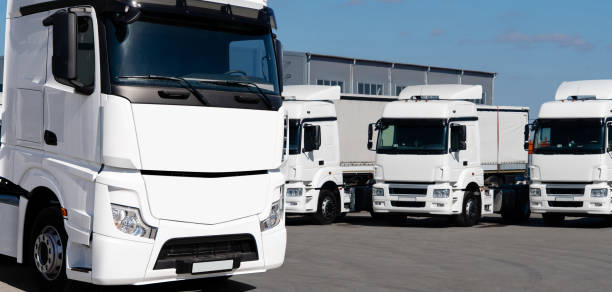 istock Fleet of white semi trucks in a row. 2172356623