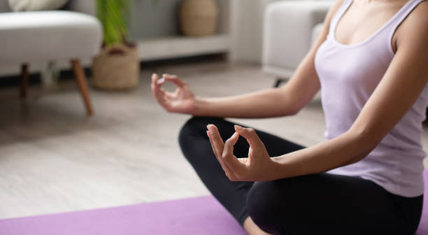 istock Woman practicing yoga, meditating at home 2172357176