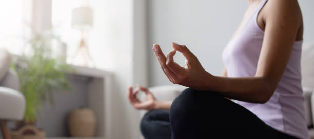 istock Woman practicing yoga, meditating at home 2172357187
