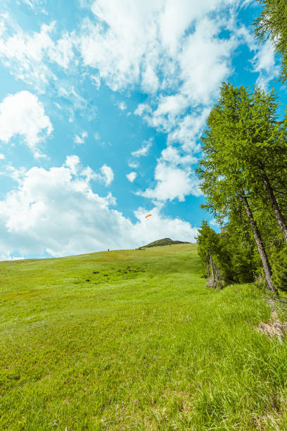 Sport Paraglider Flying with Along a Mountain Hillside on a Hot Sunny Summer Day