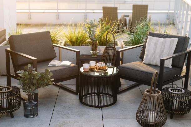 Two modern patio chairs, coffee table and lanterns on balcony