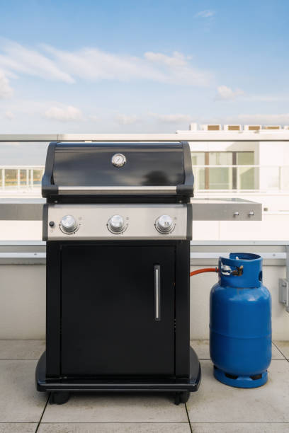 istock Gas grill with a blue propane in bottle or tank 2172357681