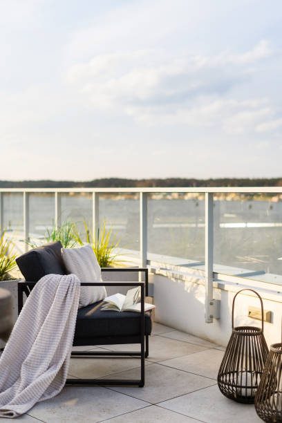 istock Balcony with water view and comfortable armchair 2172357686