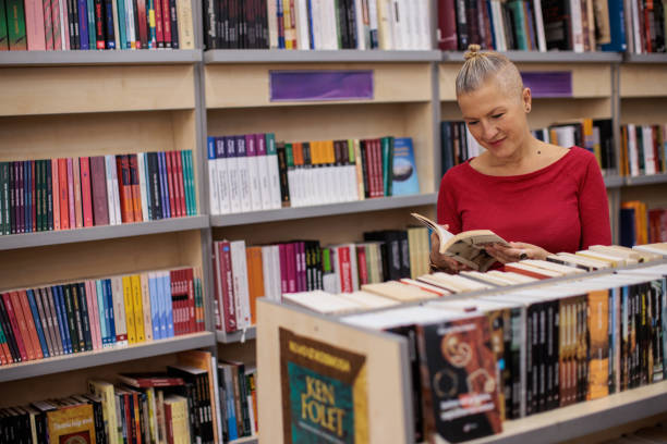 A mid adult Caucasian woman browsing books a bookstore