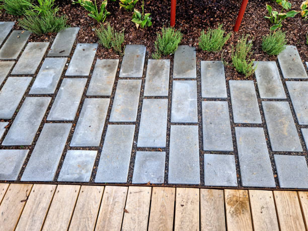 istock flat stones in the garden form a footpath with a bed mulched with bark chips. stepping stones in two rows guide visitors to the park 2172358898