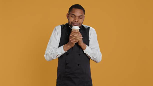istock Cheerful waiter drinking a cup of coffee and relaxing after serving clients 2172360013