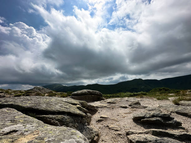 A picturesque landscape  at an elevation of a few thousand metres above see level. Rocks and clouds