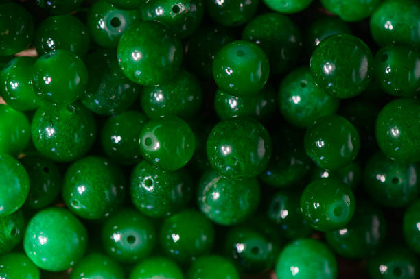 istock green real stone beads for making beads as background 2172360047