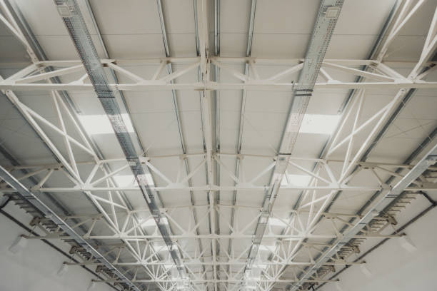 istock White metal roof frame supporting large industrial building 2172363134