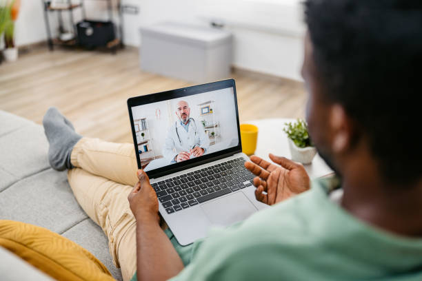 istock Young Man Having A Doctor's Appointment On The Laptop On The Sofa 2172364200