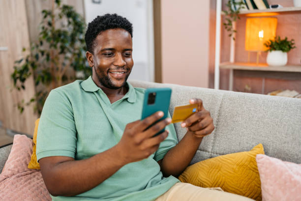 istock Young Man Shopping Online At Home Using Smart Phone 2172365365