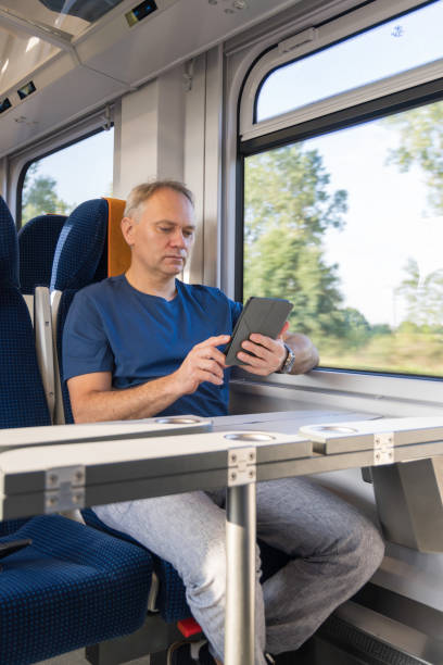 istock mature man travelling by train 2172365904