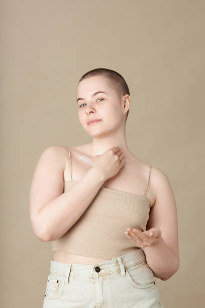 istock Girl Applying Body Cream and Smiling 2172366120