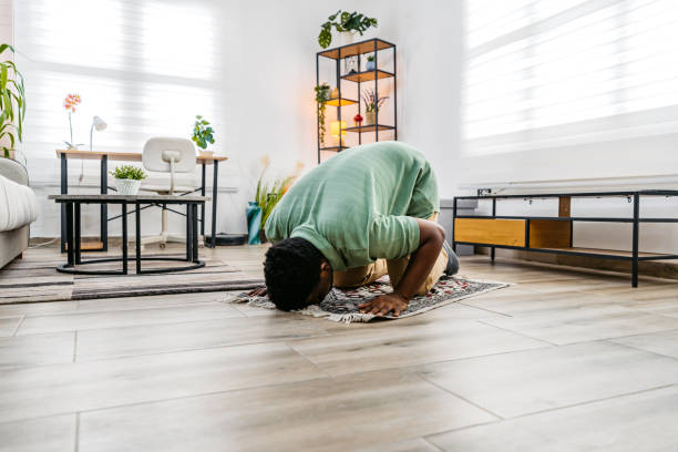 istock Young Black Muslim Man Praying At Home 2172367204