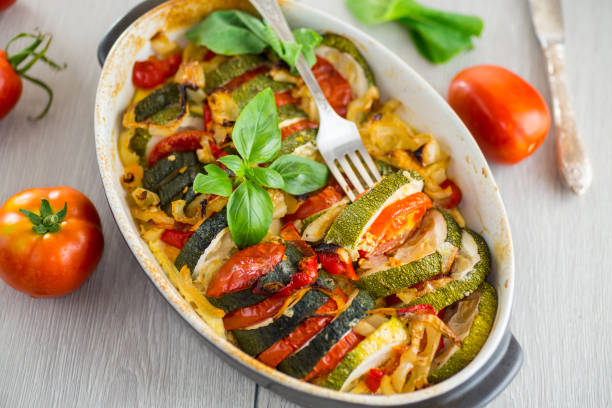 istock prepared baked zucchini and tomatoes in circles in a ceramic form, vegetable snack 2172367581