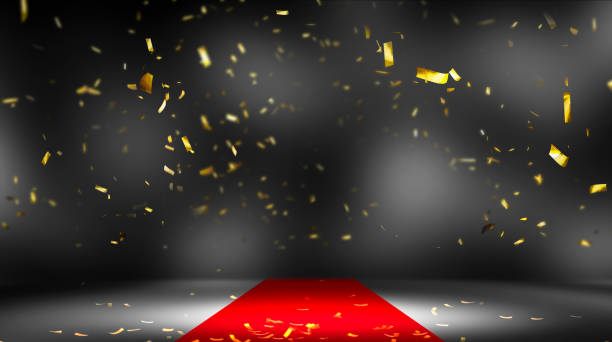 frame of falling gold confetti on red carpet on illuminated stage, bright backdrop for award ceremony, galas or red carpet events in fashion or film industry with copy space