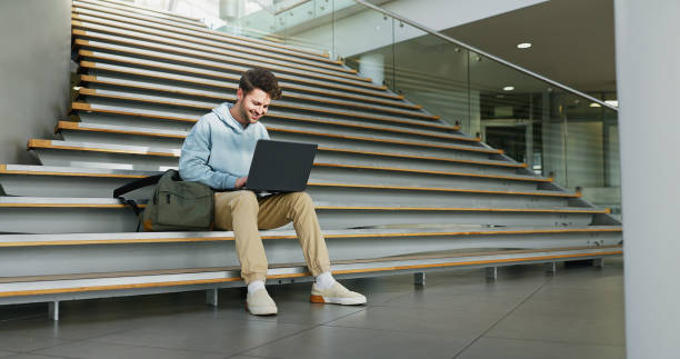Man, stairs and student on laptop for learning, assignment and books for studying on campus. Male person, online research and university for knowledge, website and registration at college institute