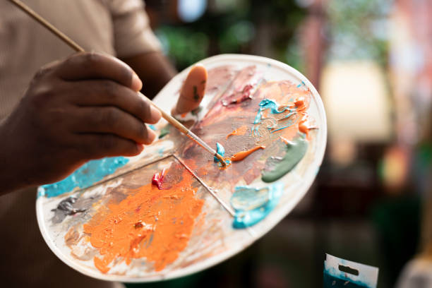 istock Painter is mixing multiple colors on a palette to apply the perfect shade 2172373358