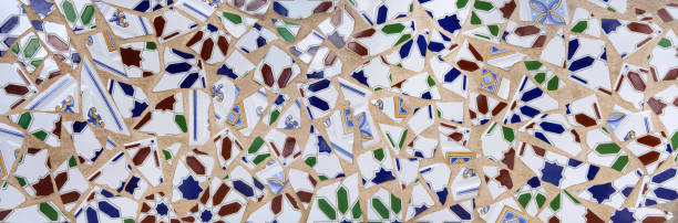 istock Abstract mosaic of roughly broken tiles on a light brown wall 2172382352