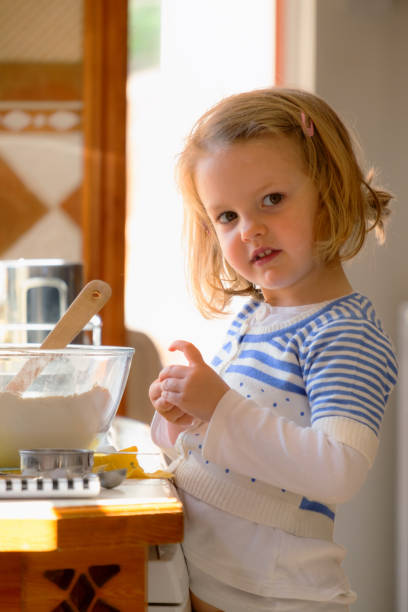 istock Little Girl Baking In Kitchen 2172384572