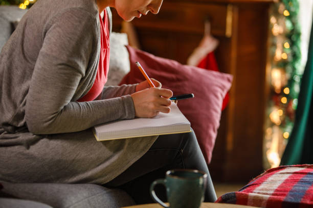 istock Woman writing journal while enjoying Christmas holidays 2172385173