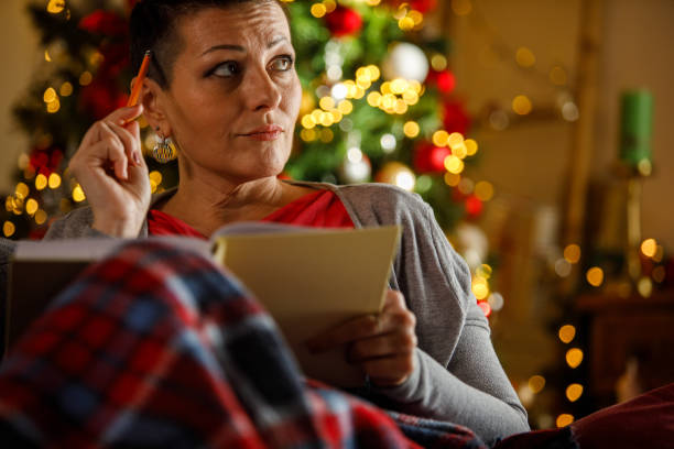 istock Woman writing journal while enjoying Christmas holidays 2172385174