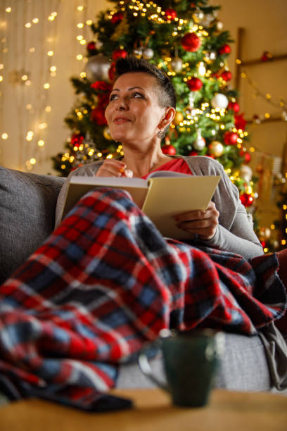 istock Woman writing journal while enjoying Christmas holidays 2172385175