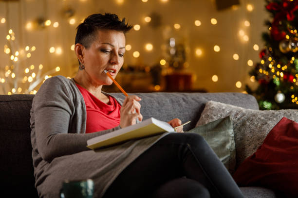 Woman writing journal while enjoying Christmas holidays
