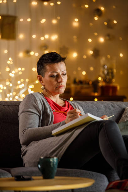 istock Woman writing journal while enjoying Christmas holidays 2172385182