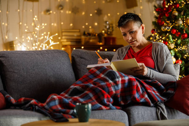 istock Woman writing journal while enjoying Christmas holidays 2172385186