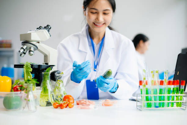 istock Two Asian scientists in a lab conducting food research using a microscope and lab equipment, showcasing innovation in food science 2172385912
