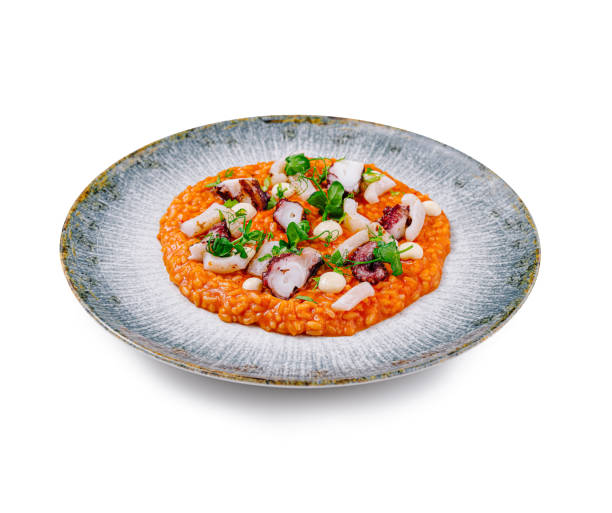 istock Seafood risotto with octopus and herbs is served on a beautiful plate 2172389517