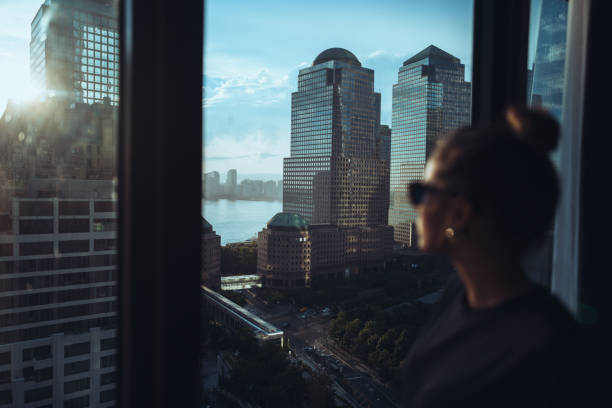 istock Woman by skyscraper window in New York Manhattan 2172391577